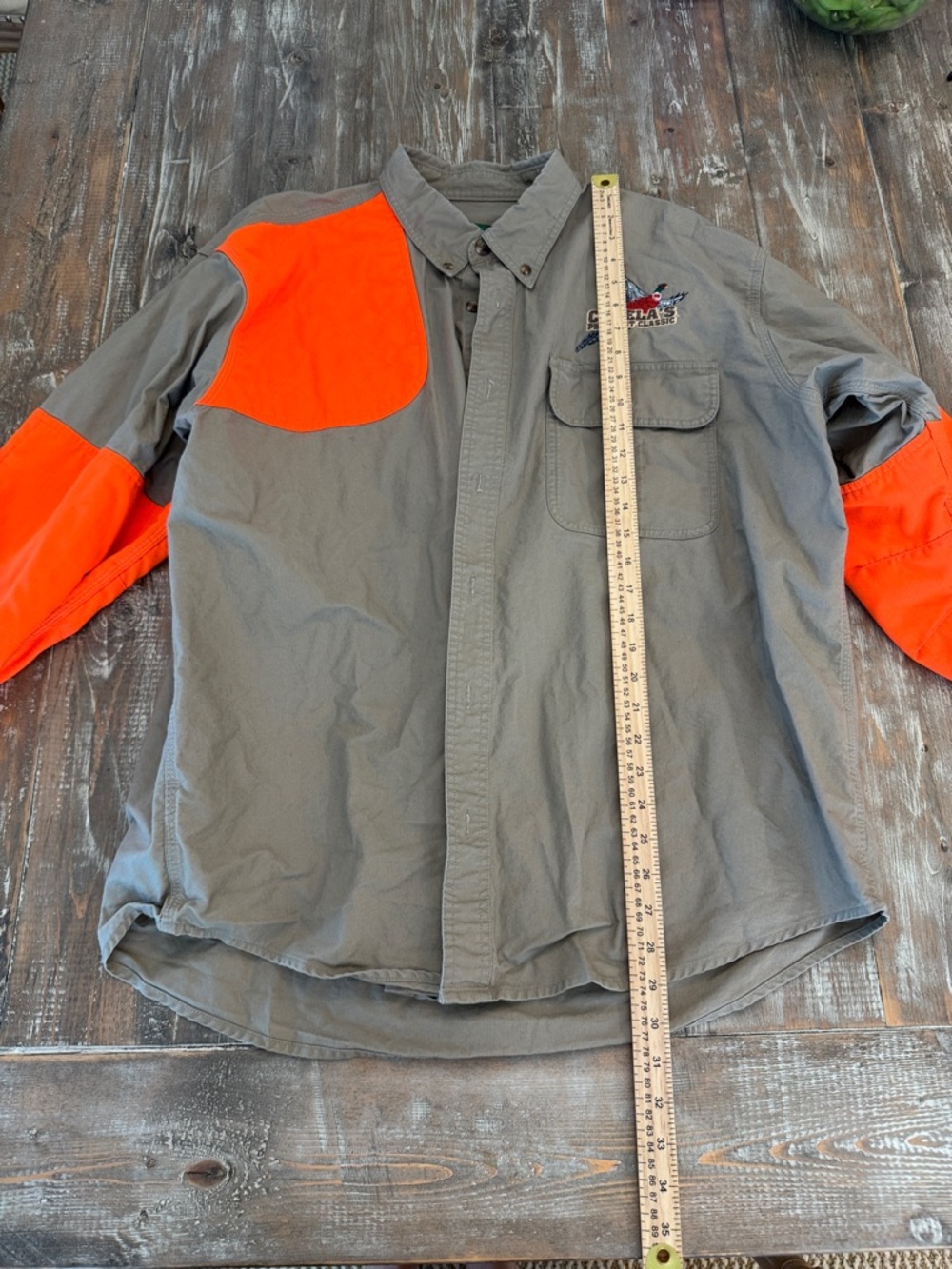 Cabela's Tan Shirt with Green and Yellow Logo Patch